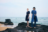Two women wearing long denim skirts